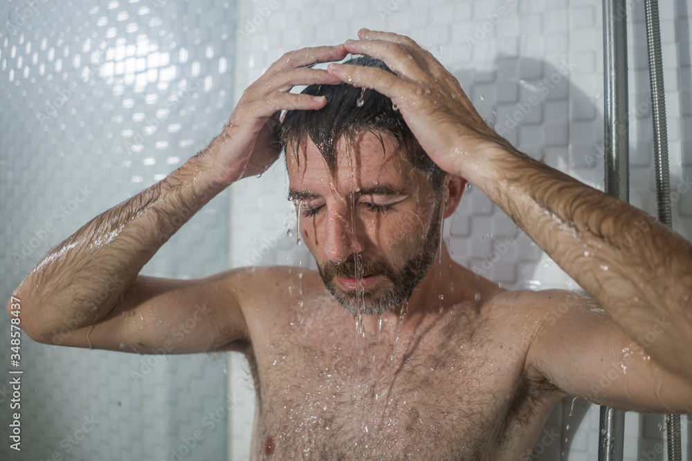 home bathroom dramatic portrait of young attractive sad and depressed man in the shower suffering depression crisisl feeling overwhelmed by life problem home bathroom dramatic portrait of young attractive sad and depressed man in the shower suffering depression crisisl feeling overwhelmed by life problem