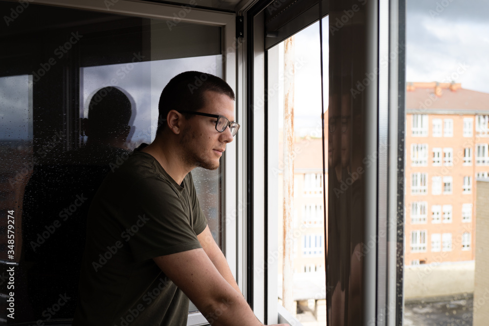 quarantined man looking out the window quarantined man looking out the window