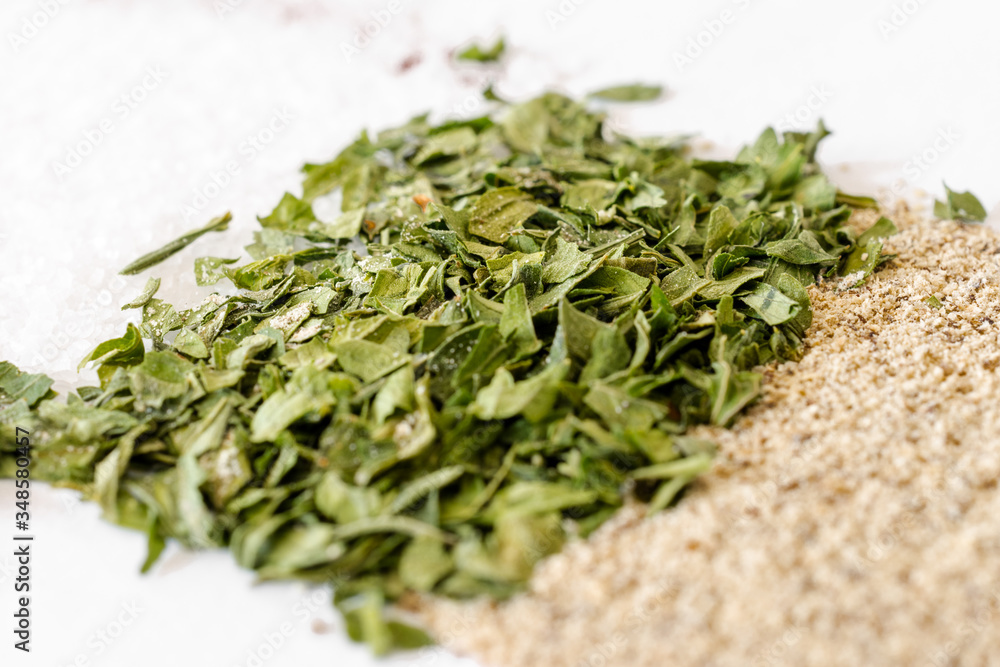 Thin layer of parsley on a white table. Thin layer of parsley on a white table.