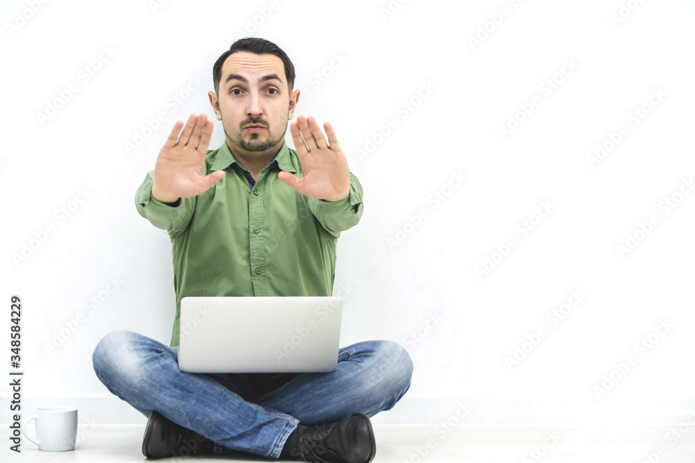 Businessman involved in work, showing stop gesture, so that nobody disturb him against white background. Businessman involved in work, showing stop gesture, so that nobody disturb him against white background.