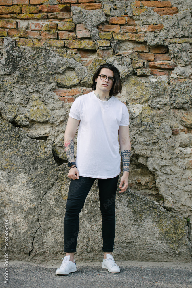 Hipster handsome male model wearing white blank t-shirt with space for your logo or design in casual urban style Hipster handsome male model wearing white blank t-shirt with space for your logo or design in casual urban style