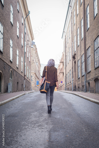 Woman walking on city street 