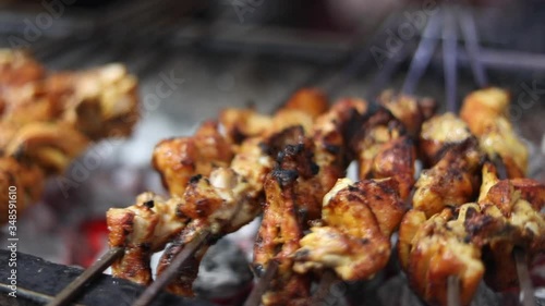 Cooking chicken tikka on a tandoori barbecue charcoal grill. Aslam Chicken, Jama Masjid, Old Delhi Street Food / Ramadan Food / Sehri /Eid 2020 Delicious pieces perfectly red. photo