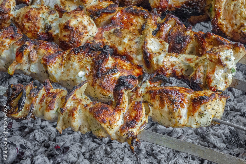 Chicken, kebab grilled on charcoal strung on skewers with aromatic toasted crust.