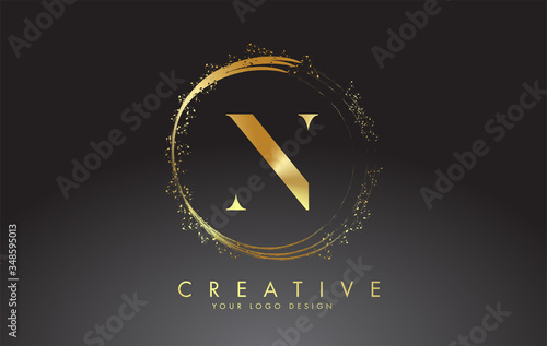 N golden letter logo with golden sparkling rings and dust glitter on a black background. Luxury decorative shiny vector illustration. photo