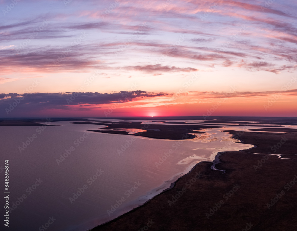Manych-Gudilo lake at dawn from above. Beautiful pink sky with clouds.
