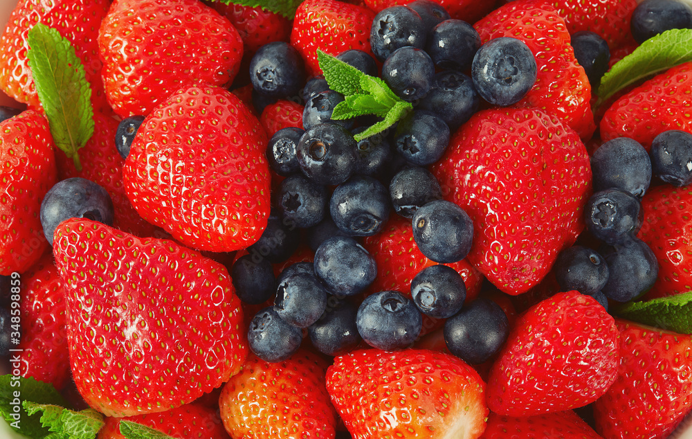 Obraz premium strawberries and blueberries in a bowl isolated on white