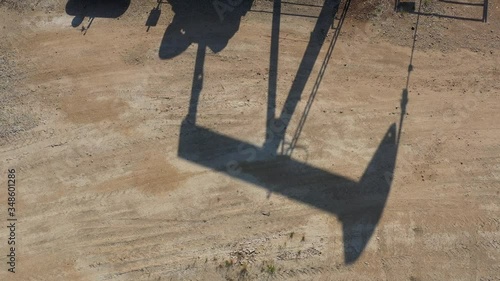 Shadow of an oil well pump jack, Burleson County, Texas, USA photo