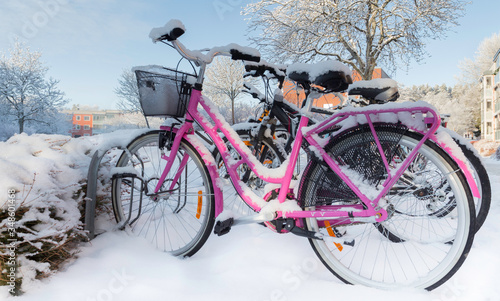 Colorful bicycles covered with snow after a snow fall on a sunny day. Beautiful winter. No one. Swedish winter. Lots of snow. Blizzard Stockholm, Sweden