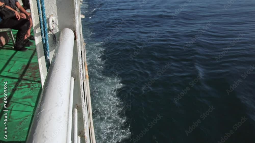 Side Of A Moving Ferry Boat Travelling On The Blue Ocean With Waves Splashing. - close up shot Side Of A Moving Ferry Boat Travelling On The Blue Ocean With Waves Splashing. - close up shot