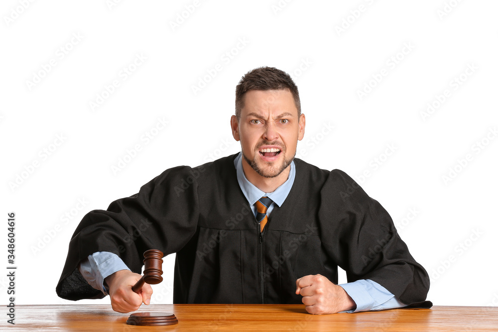 Angry male judge at table on white background Angry male judge at table on white background