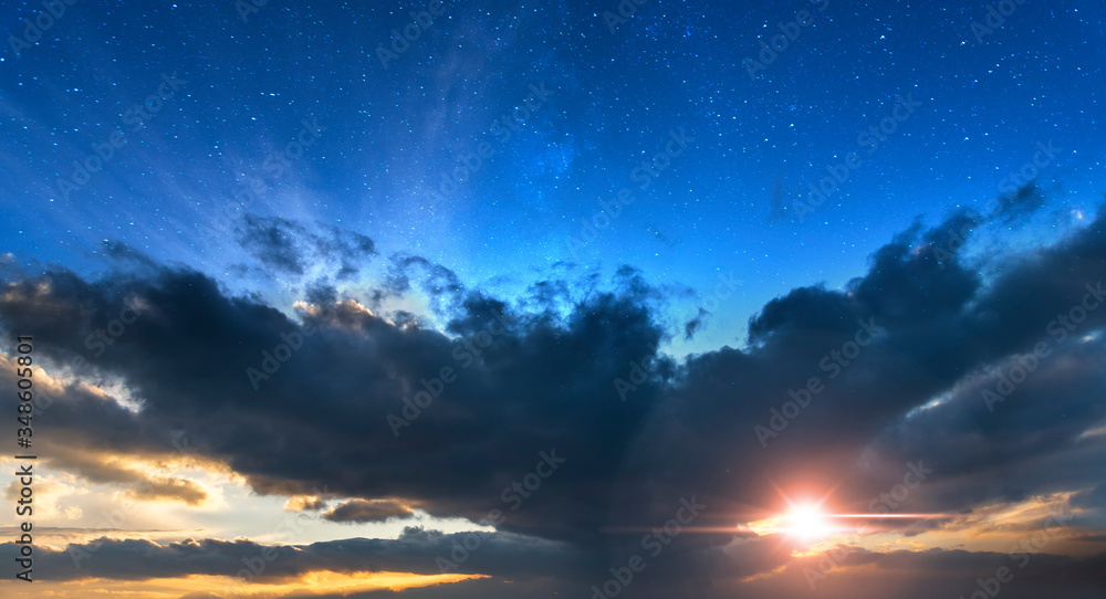 Beautiful bright sunset sky with clouds. Dramatic colorful orange sunset, blue starry sky . Nature backgrounds.