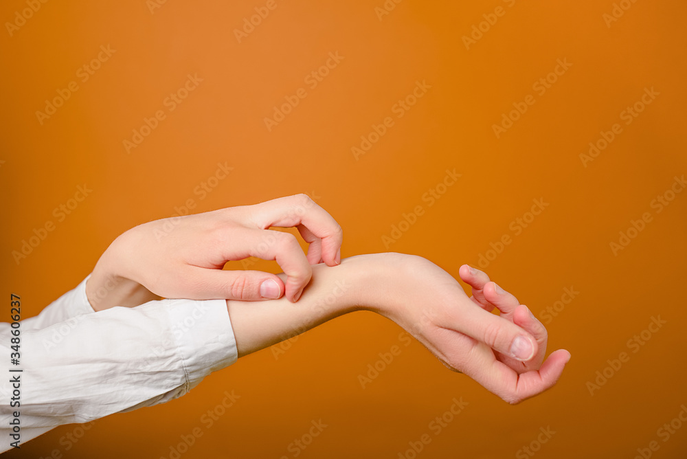 Concept skin allergy. Close up of woman scratches her hands isolated on brown background with copy space. Signs of dermatitis and scabies. Concept skin allergy. Close up of woman scratches her hands isolated on brown background with copy space. Signs of dermatitis and scabies.