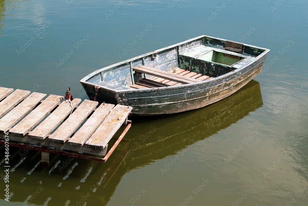An old wooden boat in the river near An old wooden boat in the river near
