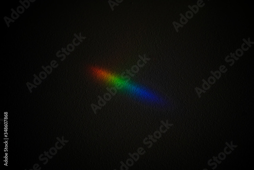 Light reflection through a prism into red green and blue photography colors. Chromatic pattern of rainbow colors. Horizontal view of conceptual rgb icon isolated on black background.