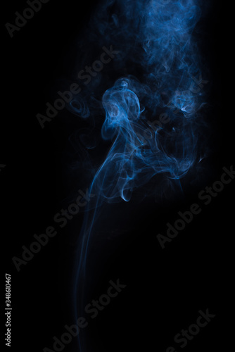The movement of the smoke on a black background .