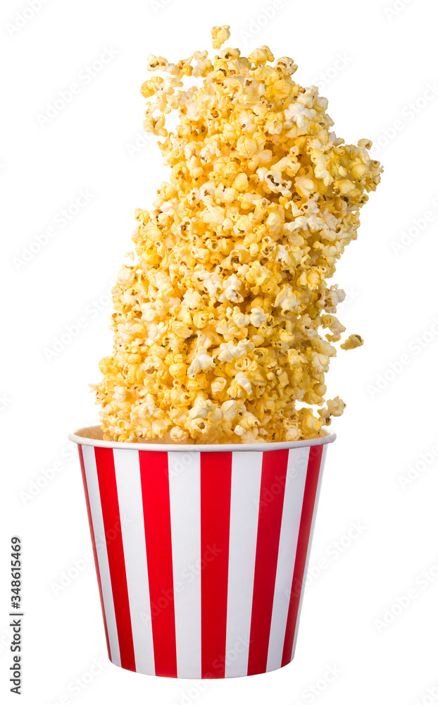 Flying popcorn from paper striped bucket isolated on black background Flying popcorn from paper striped bucket isolated on black background