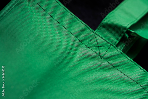 part of a bright green eco-bag made of non-woven textiles