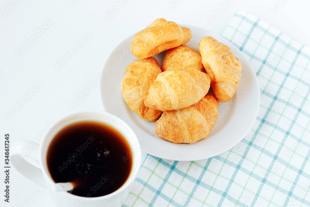Mini croissants and cup of coffee on white background. Mini croissants and cup of coffee on white background.