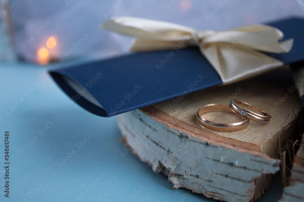 Wedding invitations and wedding rings on a blue background with a veil. Wedding invitations and wedding rings on a blue background with a veil.