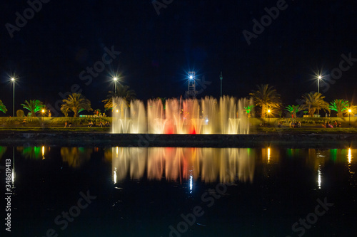 Night photo, selective focus. A famous attraction in Batumi is the bright singing and dancing fountains on the promenade. Adjara Autonomous Republic, Georgia, Eurasia. Festive mood.