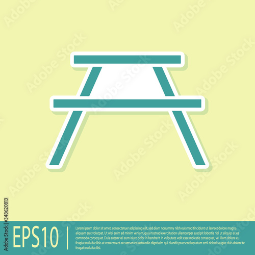 Green Picnic table with benches on either side of the table icon isolated on yellow background. Vector