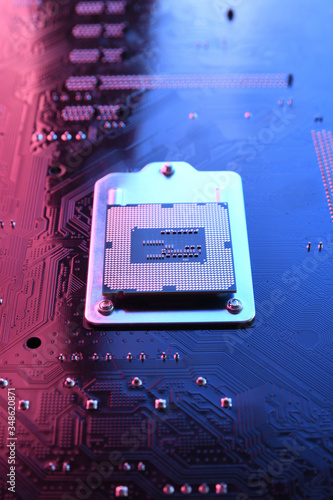 Obraz na płótnie Computer cpu processor chip on circuit board ,motherboard background. Close-up. With red-blue lighting
