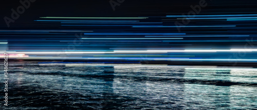 Abstract blue light trails reflected in the water