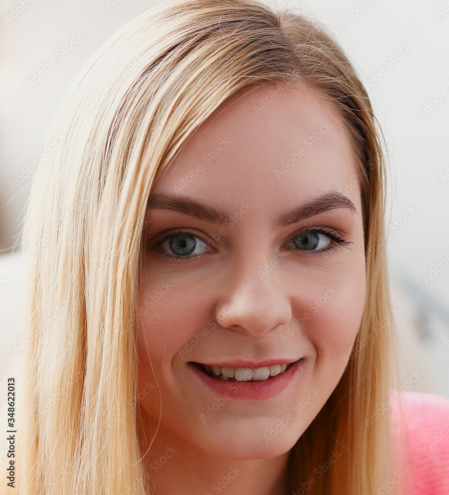 portrait of beautiful young blond woman sit on sofa in room early morning portrait of beautiful young blond woman sit on sofa in room early morning