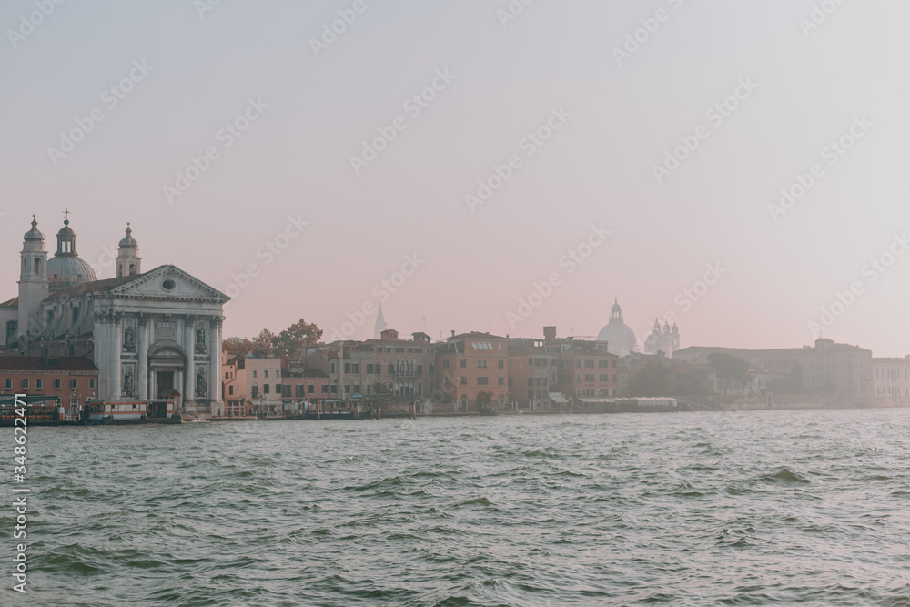 Fototapeta premium The beautiful, sunny streets of Venice, ancient buildings, canals and roofs