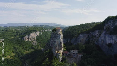 Katskhi pillar. Alone man's monastery near the village of Katskhi. The orthodox church and the abbot cell on a rocky cliff. Imereti, Georgia.