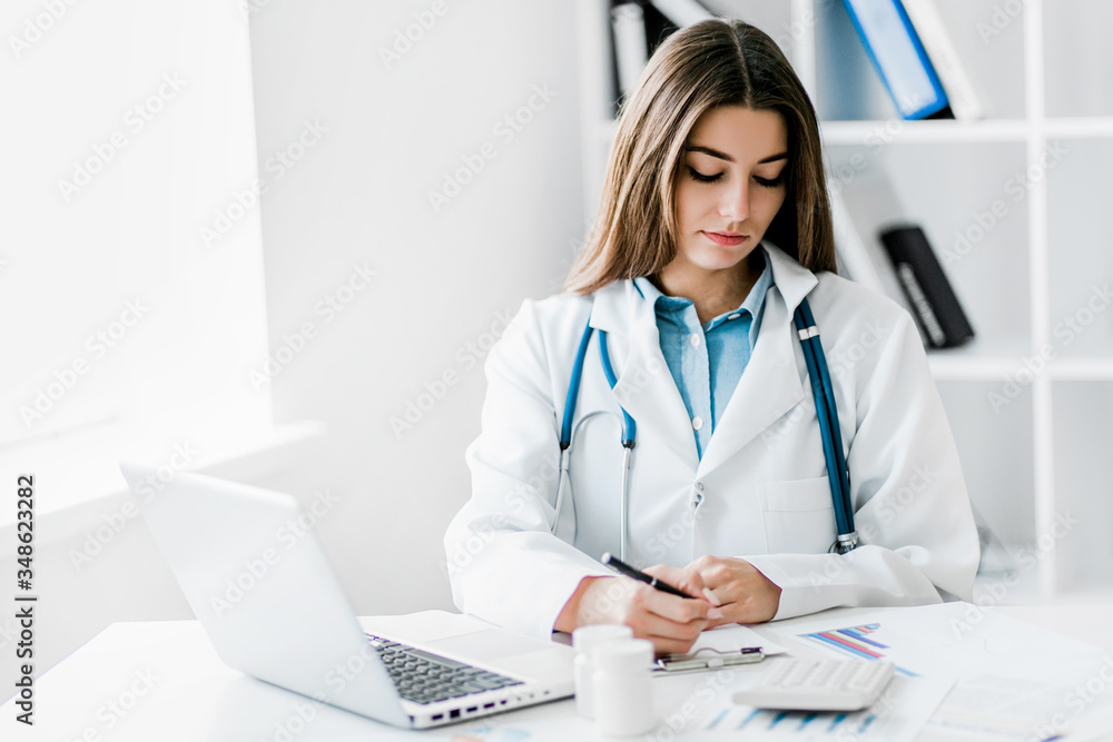 Female doctor working at office desk, healthcare professionals. Female doctor working at office desk, healthcare professionals.
