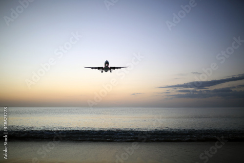 airplane landing at sunset Phuket, Thailand