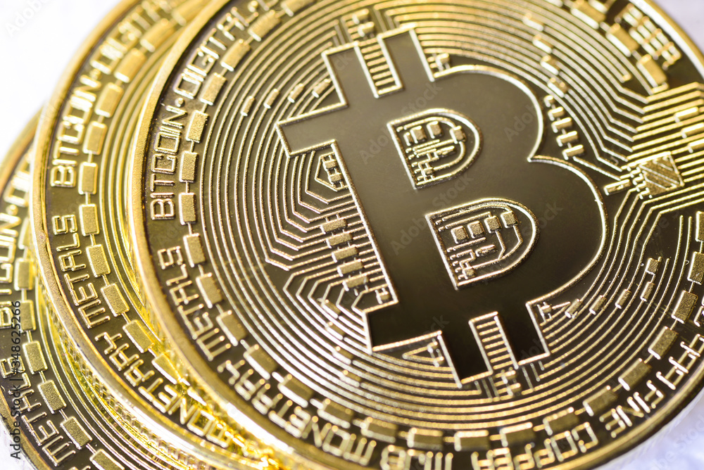 Crypto currency Closeup Golden Bitcoins. Photo virtual money.Blockchain technology, bitcoin mining concept.