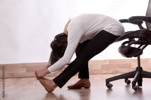 A woman does gymnastics and stretches at home and in the office