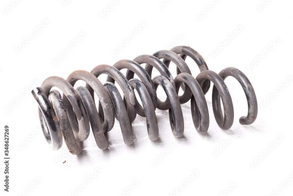 Two metal springs of shock absorbers of a running gear twisted together on a white isolated background in a photo studio. Two metal springs of shock absorbers of a running gear twisted together on a white isolated background in a photo studio.