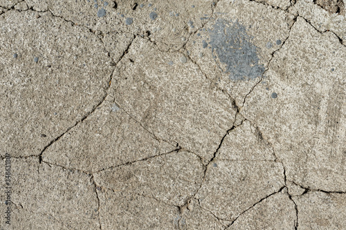 Old gray cracked cement. Large cracks in the concrete