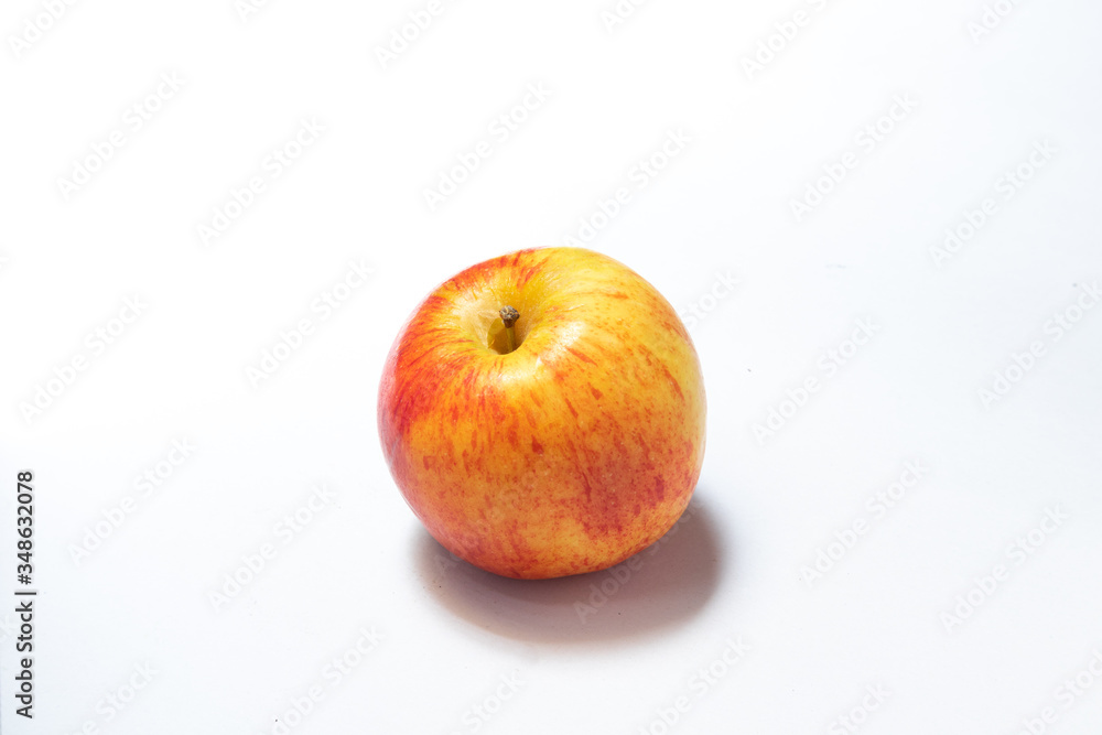 An apple with red and yellow on white background with shadow An apple with red and yellow on white background with shadow