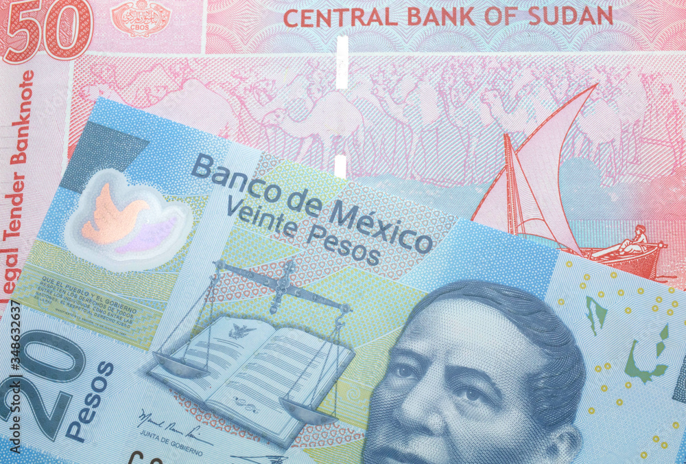 Fototapeta premium A twenty Mexican peso note with a fifty pound note from Sudan close up in macro