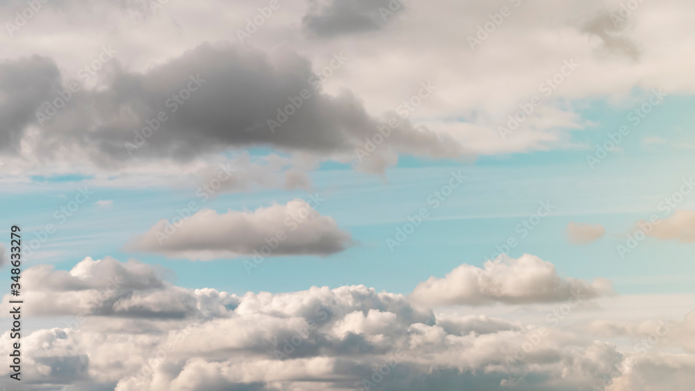 Lush, voluminous, white clouds in a clear blue sky with dark clouds, illuminated by the rays of the sun on a Sunny day. Lush, voluminous, white clouds in a clear blue sky with dark clouds, illuminated by the rays of the sun on a Sunny day.