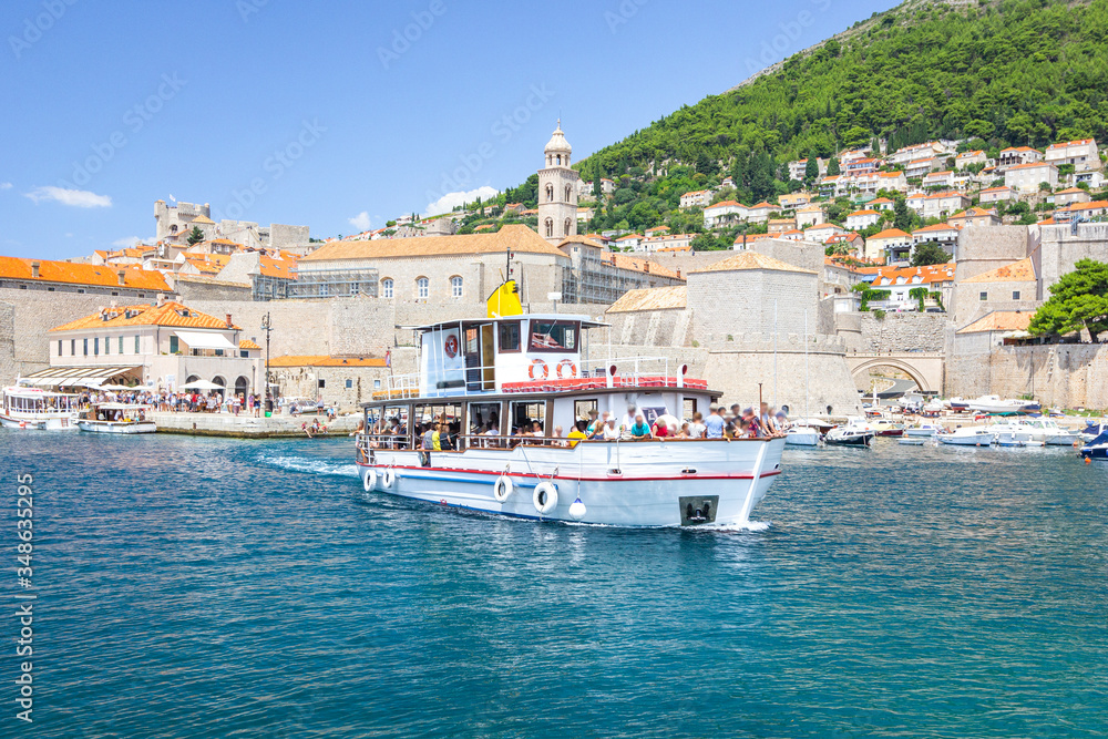 Panorama of Dubrovnik - view from sea with blue water of old town and harbor with yachts and boats, Dubrovnik, Croatia.