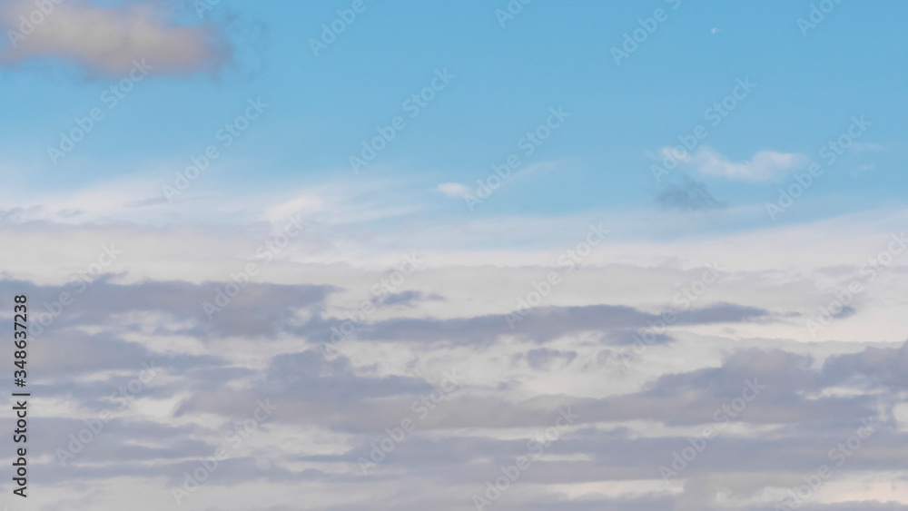 Sky with clouds. Lush, large Cumulus clouds in a clear blue sky illuminated by the rays of the sun on a Sunny day. Realistic sky background. Template. Sky with clouds. Lush, large Cumulus clouds in a clear blue sky illuminated by the rays of the sun on a Sunny day. Realistic sky background. Template.