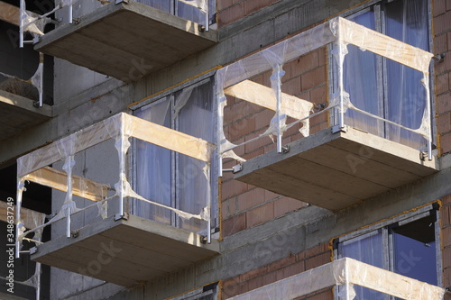 New building under construction and construction site of a residential building. the formation of cement supports in prefabricated forms. modern building under construction and scaffolding