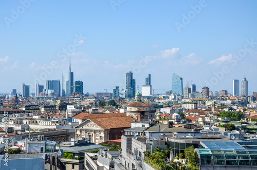 Aerial panoramic view from roof of Milan cathedral Duomo, modern architecture of city downtown, offices and residential buildings in Porto Nuovo business district on background