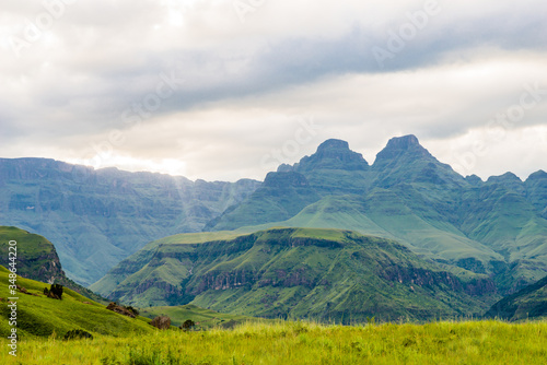 Südafrika, KwaZulu-Natal, Giants Castle Game Reserve, Cathedral Peak in den Drakensbergen, Grüne Berglandschaft unter grauer Wolkendecke © ONEWORLD PIC