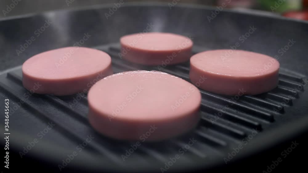 rings of tasty sausage are roasted on the grilling pan rings of tasty sausage are roasted on the grilling pan
