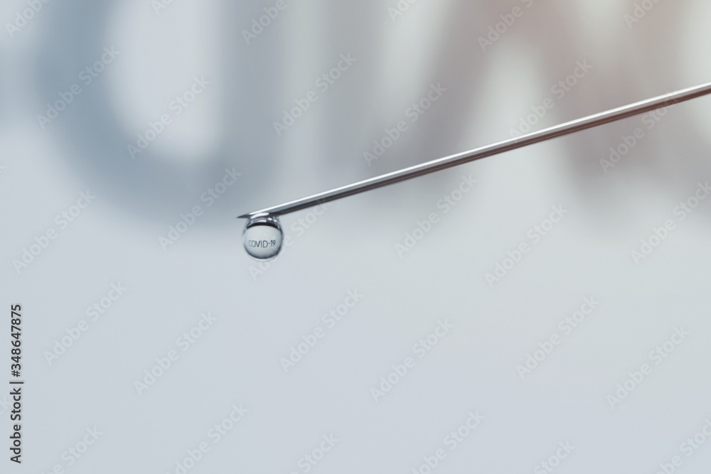 COVID-19 word reflected inside vaccine drop. Corona virus Vaccine injection COVID-19 word reflected inside vaccine drop. Corona virus Vaccine injection