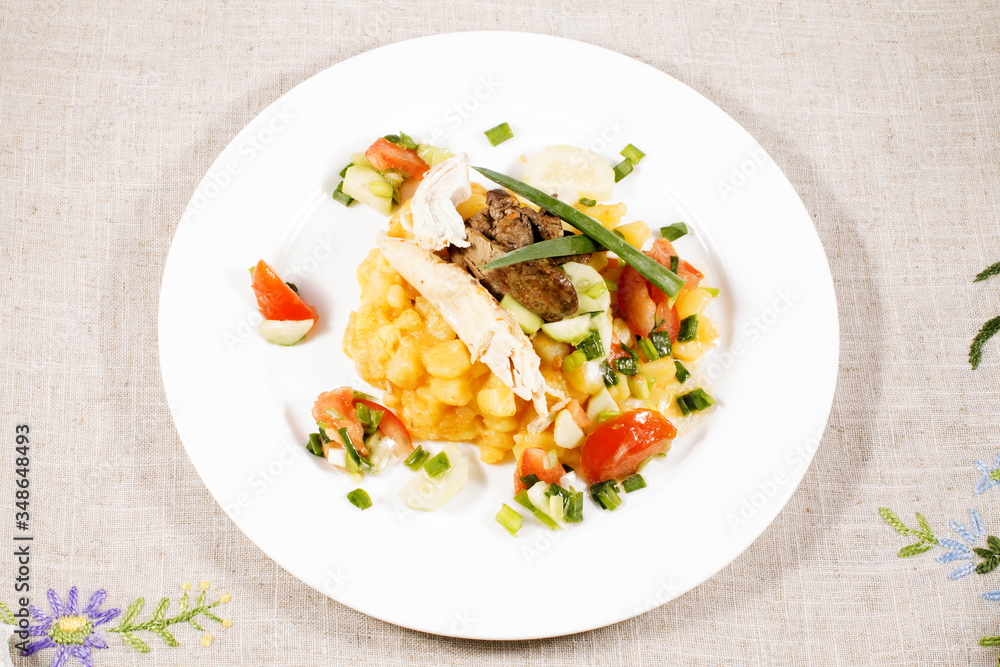 close up of potato with chicken with vegetables and salad on plate close up of potato with chicken with vegetables and salad on plate