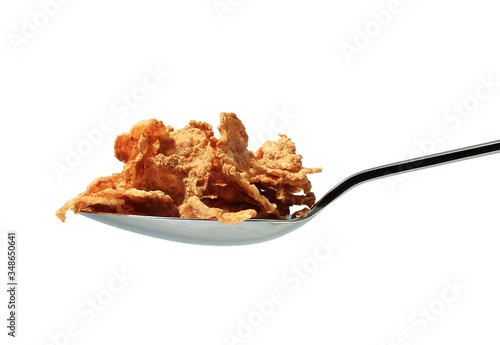 close up of spoon with muesli on white background