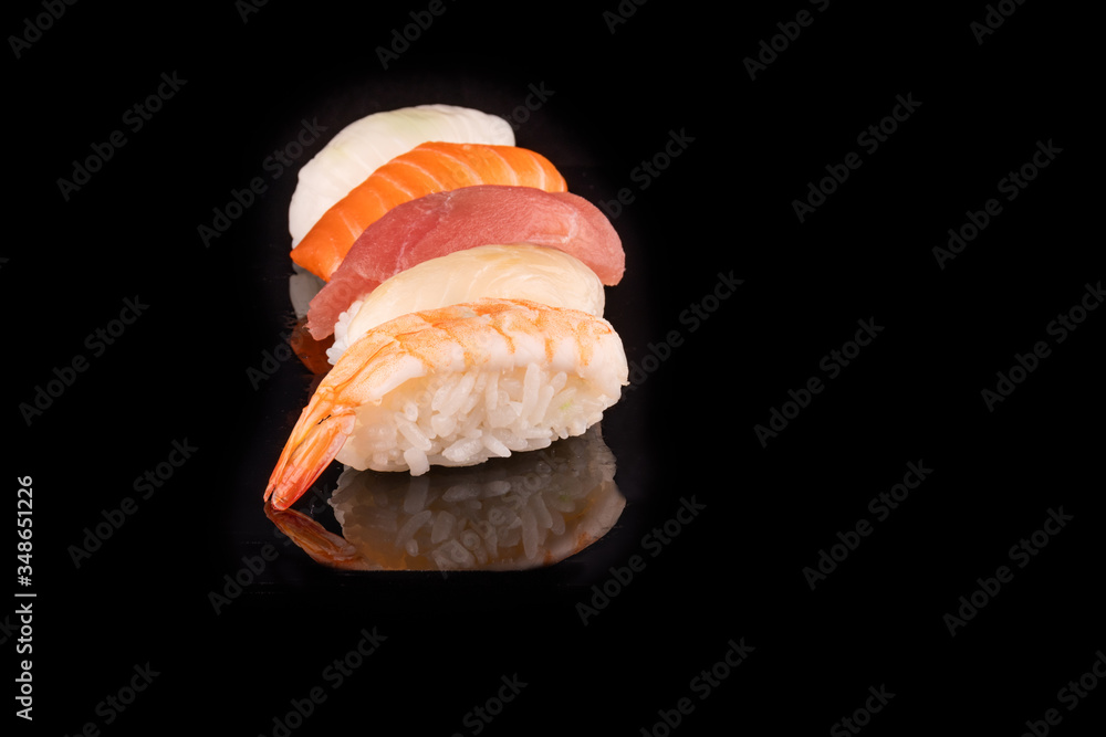 Simple sushi nigiri maki set isolated on black background. Various selection of traditional japanese Simple sushi nigiri maki set isolated on black background. Various selection of traditional japanese